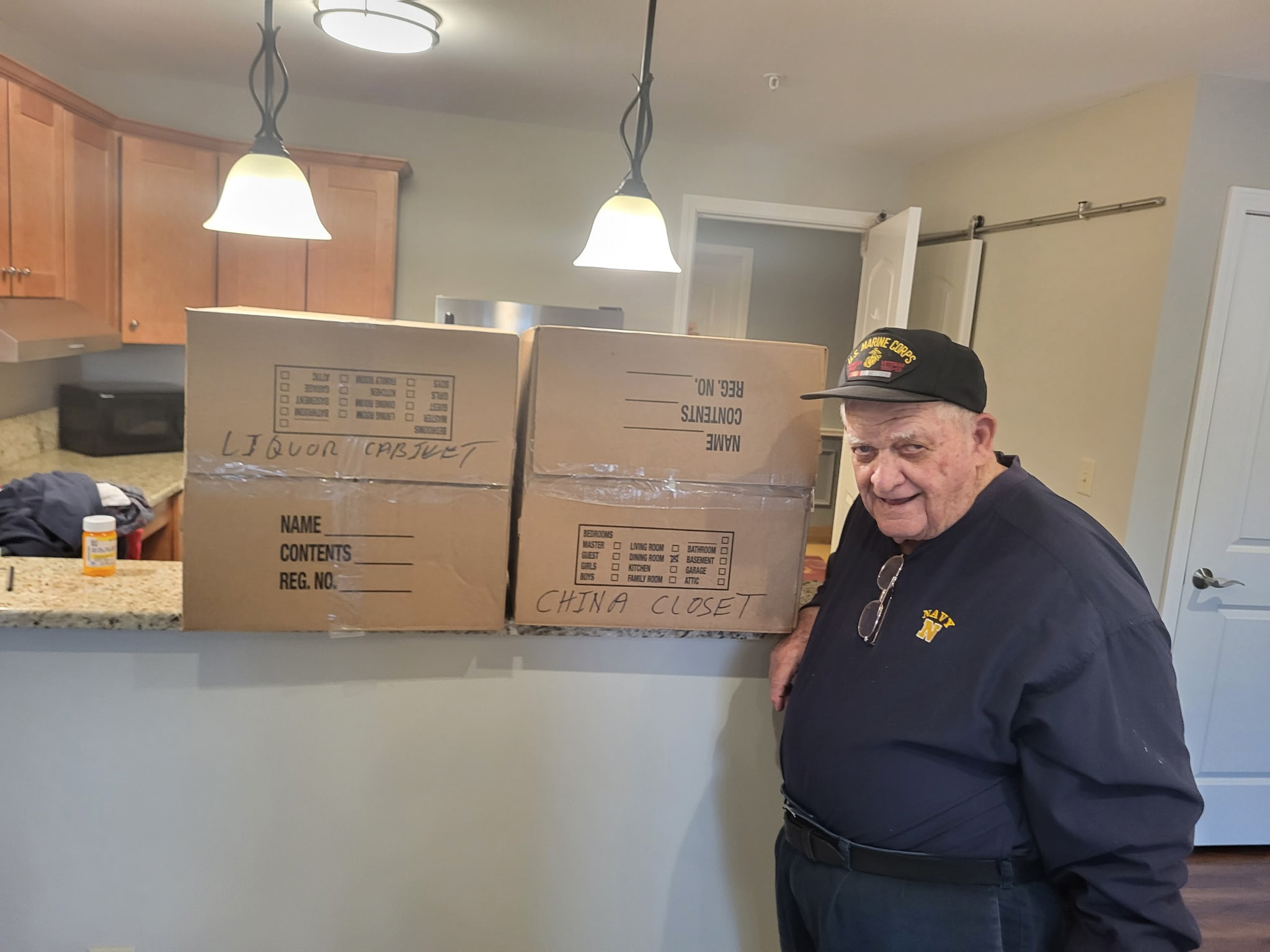 Veteran standing beside donated moving boxes